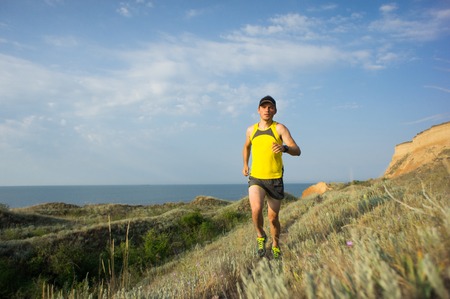 Sport running man in cross country trail runの写真素材