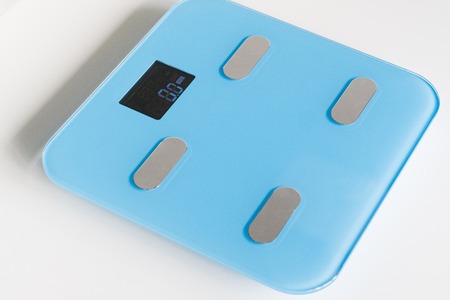 Kitchen scale over white backgroundの写真素材