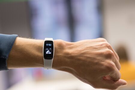 Runner checking progress on smart watch. Fit male runner exercise training