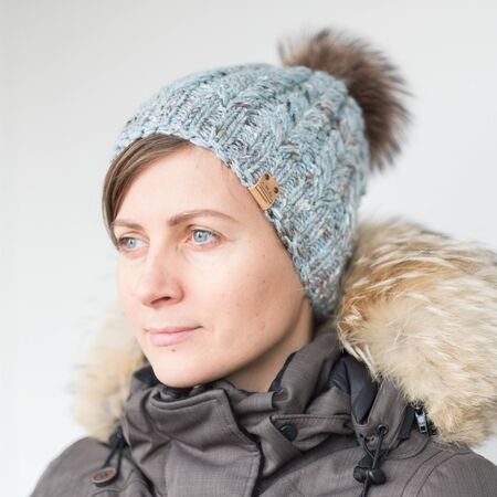 Pretty young woman wearing a hat with pomの写真素材