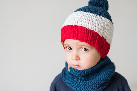 funny cute kid in knitted hatの写真素材
