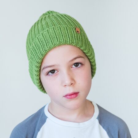 funny cute kid in knitted hatの写真素材