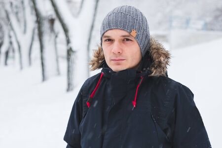 Cool man in winter fashion. Wearing scarf and knit hatの写真素材