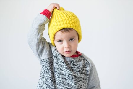 funny cute kid in knitted hatの写真素材