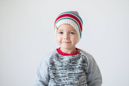 funny cute kid in knitted hatの写真素材