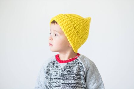 funny cute kid in knitted hatの写真素材