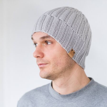 Cool man in winter fashion. Wearing scarf and knit hatの写真素材