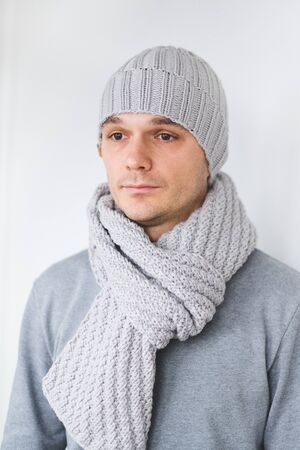 Cool man in winter fashion. Wearing scarf and knit hatの写真素材