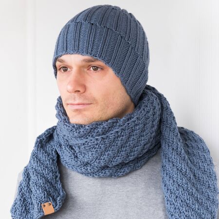 Cool man in winter fashion. Wearing scarf and knit hatの写真素材