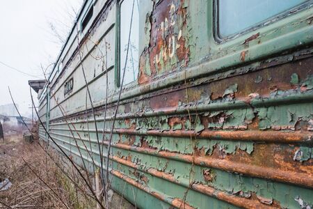 old rusty weathered peeled paint of an old wagon. Blue abandoned railway carriage. Old railwaystationの写真素材