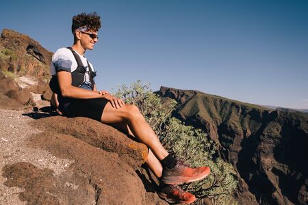 Portrait of young man resting after trail runningの写真素材