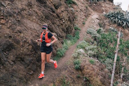 Sport running woman in cross country trail run