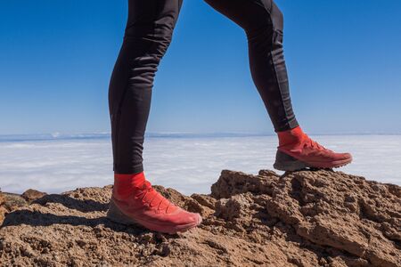 Successful runner hiker enjoy the view on mountain top cliff edge. Tenerife, Spainの写真素材