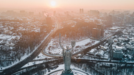 Panoramic aerial view of winter city Kyiv covered in snow. The Motherland Monumentの写真素材