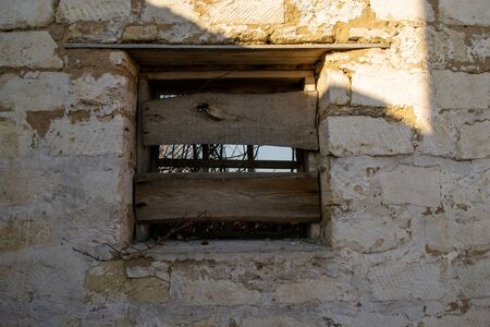 Boarded up window on an old buildingの写真素材