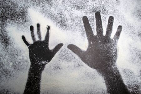 Background black footprint of a child and adult hands on a white textureの写真素材