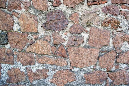 Background wall masonry of red granite stoneの写真素材
