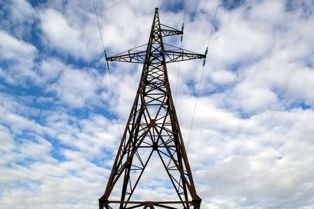 High voltage metal electric pole against the skyの写真素材