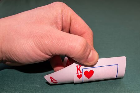 cards in hand ace and king on a green backgroundの写真素材