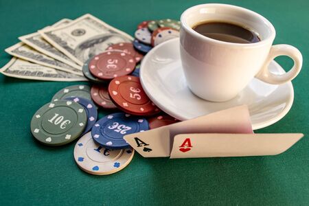 Poker chips, dollars, two aces on a green backgroundの写真素材