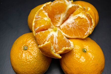Peelless tangerine on tangerines on a black backgroundの写真素材