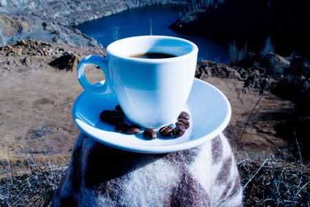 Cup with coffee on the background of canyon at sunriseの写真素材