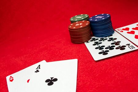 Playing cards aces and tens on a red background