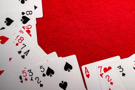 Playing cards on red backgroundの写真素材