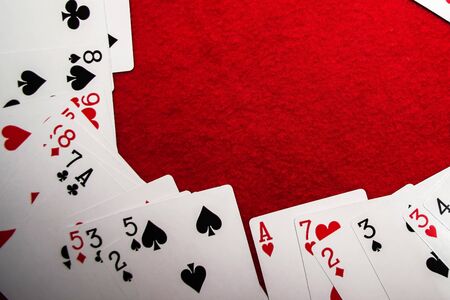 Playing cards on red background