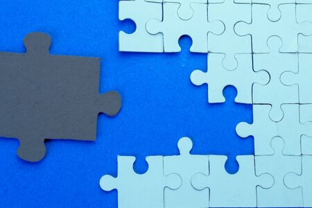 Blue puzzles on a blue background close-upの写真素材