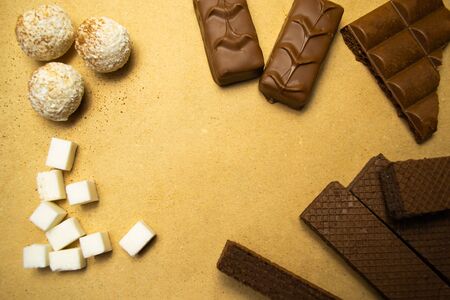Background of chocolate sweets, refined sugar, truffles.