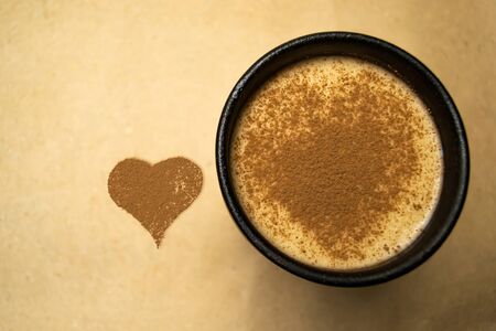 Heart of cocoa and cocoa with milk in a cupの写真素材