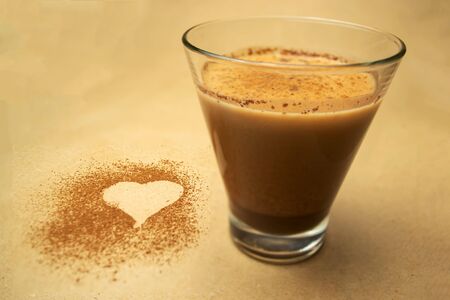 Cocoa milk in a glass, heart made of cocoa powderの写真素材