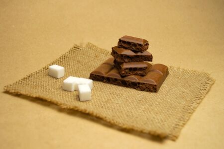 Milk porous chocolate, refined sugar on a napkinの写真素材