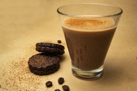 Cocoa milk in a glass, two chocolate chip cookiesの写真素材