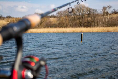 Bait on a fishing rod on the background of the riverの写真素材