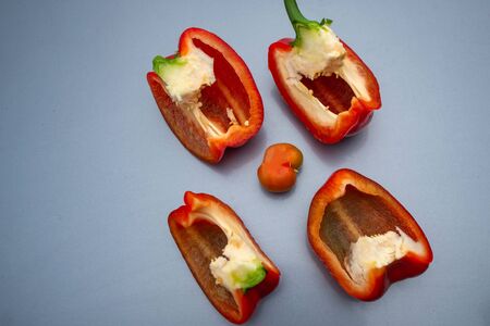Red juicy bell pepper cut into fourの写真素材