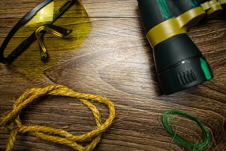 Glasses, binoculars, rope, fishing line, on wooden backgroundの写真素材