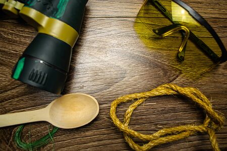 Glasses, binoculars, wooden spoon, fishing line, on wooden backgroundの写真素材