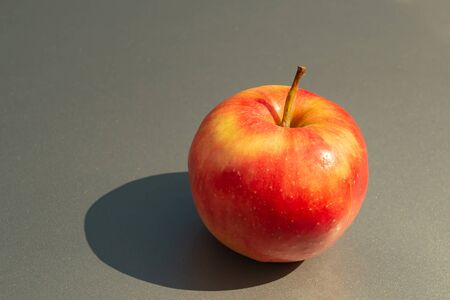 Juicy ripe apple fruits on a gray backgroundの写真素材