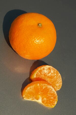 Tangerines with a slice isolated on white background.の写真素材
