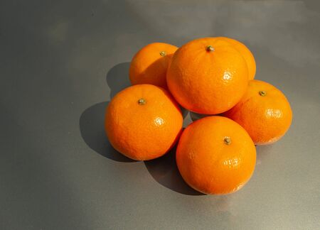 Ripe and juicy tangerines on a gray backgroundの写真素材