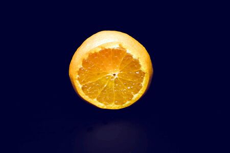 The tangerine cuts close-up. Isolated on a black background.の写真素材