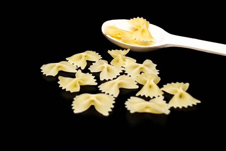 Pasta in the form of butterflies on a black backgroundの写真素材