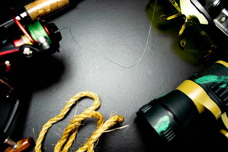 Background of fishing tackle on a black backgroundの写真素材