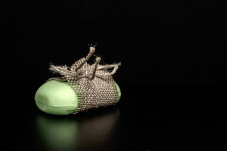Soap wrapped in cloth on a black backgroundの写真素材