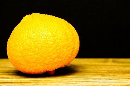 Fresh juicy tangerine on a wooden backgroundの写真素材