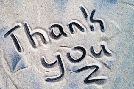 Words written in the sandThank you inscription written in sea sandの写真素材