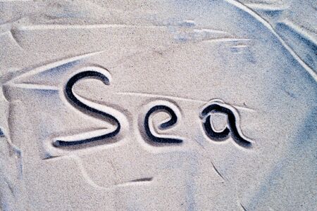 The inscription sea is written on the sea sandの写真素材