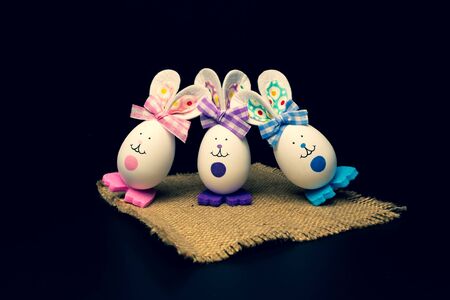 Easter eggs. Easter bunny on a napkin. Easter symbolism Black backgroundの写真素材